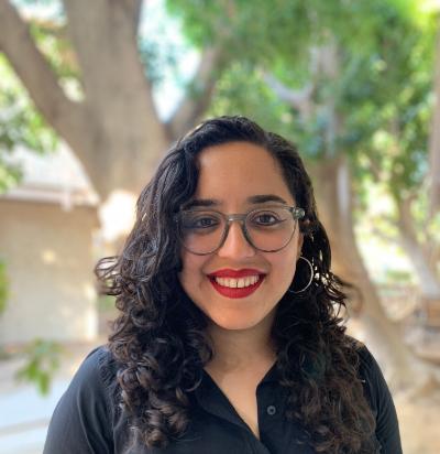 Photograph of Lizeth Zepeda, standing outside and smiling at the camera.